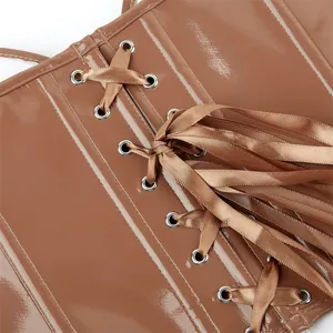 Brown patent leather corset detail view, showcasing metal grommets and satin lacing finish.