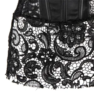Black lace corset dress detail close-up, faux leather paneling and intricate floral pattern.