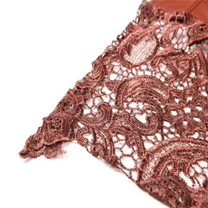 Close-up view of the exquisite brown red lace embroidery and hollow-out trim details.