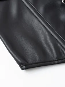 Close-up detail shot of black faux leather corset top, showing fine stitching and texture.