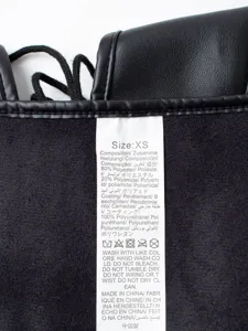 Detail view of black faux leather waist corset showing size and care label information.