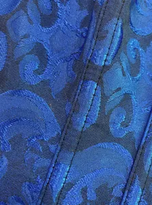 Blue jacquard corset fabric detail showing exquisite embroidery and sturdy stitching structure.