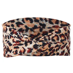 Leopard print twisted headband for women, stylish stretchy yoga hair band, fashion accessory.