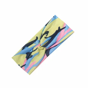 Detailed view of a colorful camouflage sports headband, twisted yoga hairband for sweat absorption.