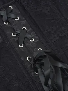 Black lace corset detail with satin ribbons and metal eyelets for women's stylish fashion outfits.