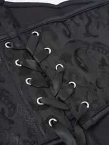 Close-up of black jacquard corset, detailed view of metal eyelets and satin lacing.