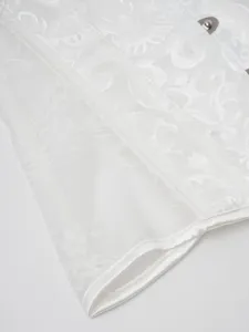 White lace jacquard corset bustier detail shot, showing exquisite floral pattern and trim.