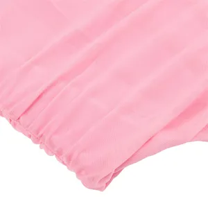 Detail shot of pink elastic mesh fabric, breathable and lightweight material for apparel production.