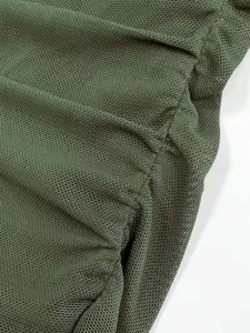 Close up view of dark green mesh fabric texture with elastic ruching design detail.