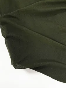 Dark green elastic mesh fabric detail close-up, breathable sheer material for apparel.
