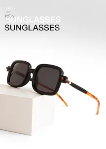 Detailed shot of trendy retro square sunglasses with chic tortoise temples on white block.