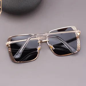 Women oversized square sunglasses with hollow metal frame and stylish gradient lenses.