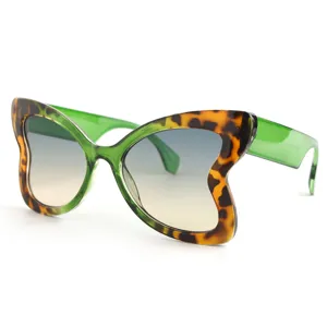 Chic butterfly sunglasses with stylish tortoiseshell frame and green temples for women.