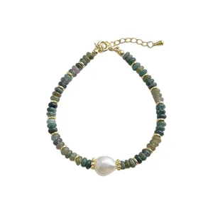 Close-up detail of natural Indian agate and freshwater pearl bracelet with gold metal spacer beads.