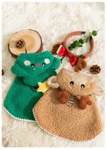 Detailed view of cute Christmas pet cloak, green tree and brown reindeer design, cozy fabric.