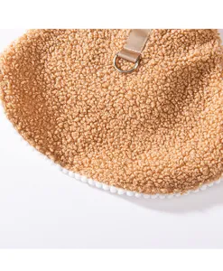 Close-up detail of soft brown fleece pet cloak with cute white pom-pom trim and sturdy D-ring.