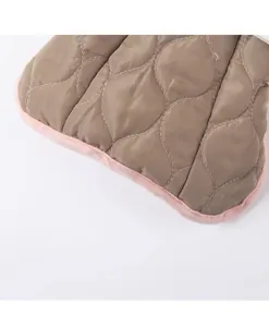 Detailed view of winter quilted pet vest for dogs and cats with warm fleece edge finish.