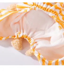 Close-up detail of striped pet clothing with 3d bear elements, soft fabric, cozy loungewear.