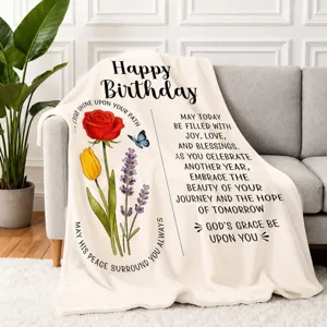 Detailed shot of flannel birthday throw blanket with floral design and warm blessing quotes.