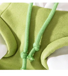 Close-up detail of pet hoodie drawstring and soft fleece texture, green and white design.