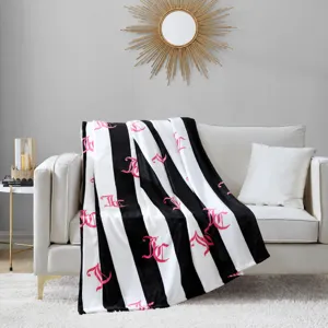 Luxury black and white striped plush throw blanket with pink JC monogram for home decor