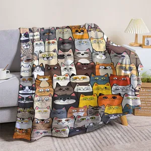 Detailed view of the cute cartoon cat pattern flannel throw blanket draped nicely on a modern sofa.
