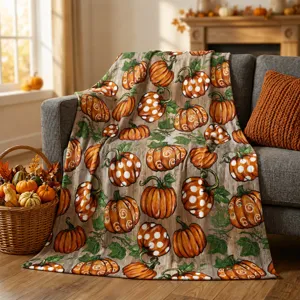 Detailed view of vintage wood grain and pumpkin printed flannel blanket in autumn room decor.