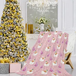 Soft pink Christmas blanket with cute vintage Santa and snowflake pattern for cozy holiday decor.