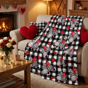 Black and white plaid flannel blanket featuring cute gnomes and red hearts, cozy home decor.