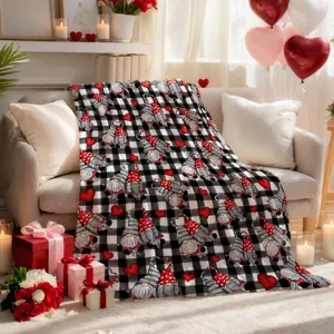 Valentine Day gnome blanket detail, black and white plaid throw with red hearts for cozy decor.