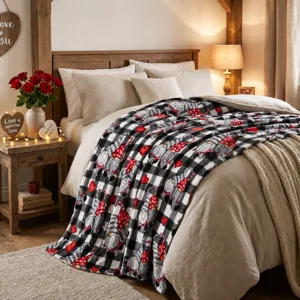 Black and white plaid flannel blanket featuring cute gnomes and hearts for cozy home decor.
