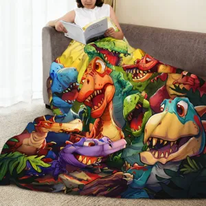 Cozy cartoon dinosaur flannel blanket lifestyle detail showing soft plush texture on sofa.