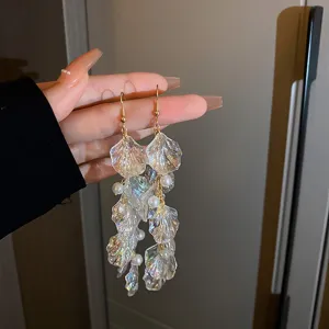 Detailed shot of vintage iridescent acrylic petal pearl tassel earrings, elegant jewelry style.