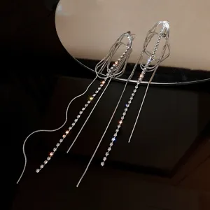 Long silver-tone multi-strand rhinestone tassel earrings, elegant minimalist sparkling jewelry design.