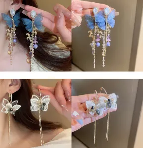 Detail shot of exquisite butterfly mesh tassel earrings, featuring crystal and pearl accents.