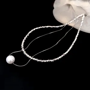 Elegant multi-layer silver bead necklace with a single white pearl pendant, stylish and chic.