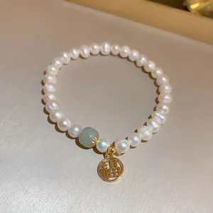 Chic Baroque freshwater pearl bracelet with green bead and gold Fu pendant for women.