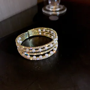 Exquisite multi-layer pearl rhinestone bracelet, elegant gold tone design for women's party wear.