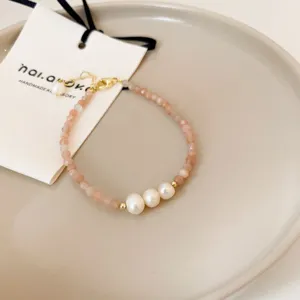 Elegant French baroque pearl bracelet with pink gemstone beads and gold details for women.