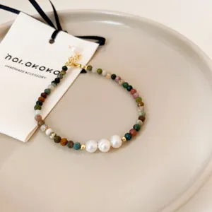 Exquisite baroque pearl and colorful gemstone beaded bracelet detail, handmade minimalist jewelry.