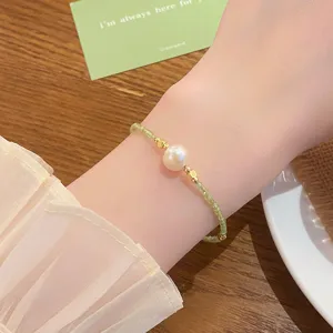 Exquisite detail view of freshwater pearl and green crystal beaded bracelet, sweet cute style.
