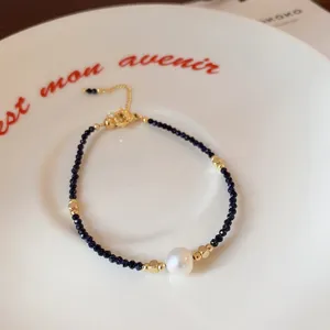 Delicate freshwater pearl and dark beaded bracelet with gold accents. Sweet ins style chic.