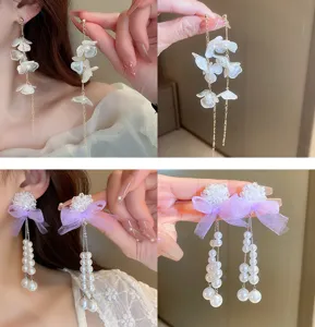 Detailed view of sweet butterfly flower and pearl tassel earrings, elegant and fairy style.