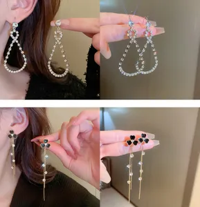 Crystal and black flower tassel earrings detail shot showing sparkling rhinestone dangling design.