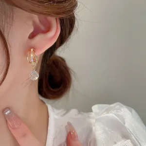 Elegant gold geometric zircon tassel drop earrings detail shot, chic jewelry design.