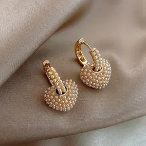 French vintage gold huggie hoop earrings featuring cute micro pearl paved heart pendants.