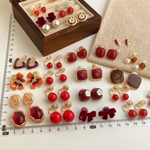 Vintage burgundy clip-on earrings set, retro design non-piercing ear clips for women detail view.