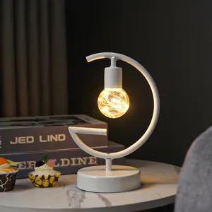 Minimalist white iron art decorative desk lamp with warm LED copper wire bulb.