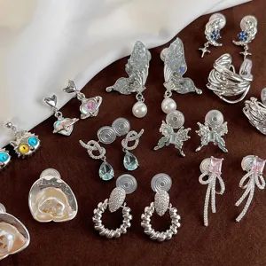 Detailed view of fashionable non-piercing clip-on earrings with cute butterfly and heart designs.