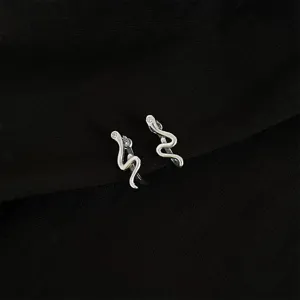 Detailed shot of silver-colored snake ear cuffs, non-pierced design, chic sweet style.